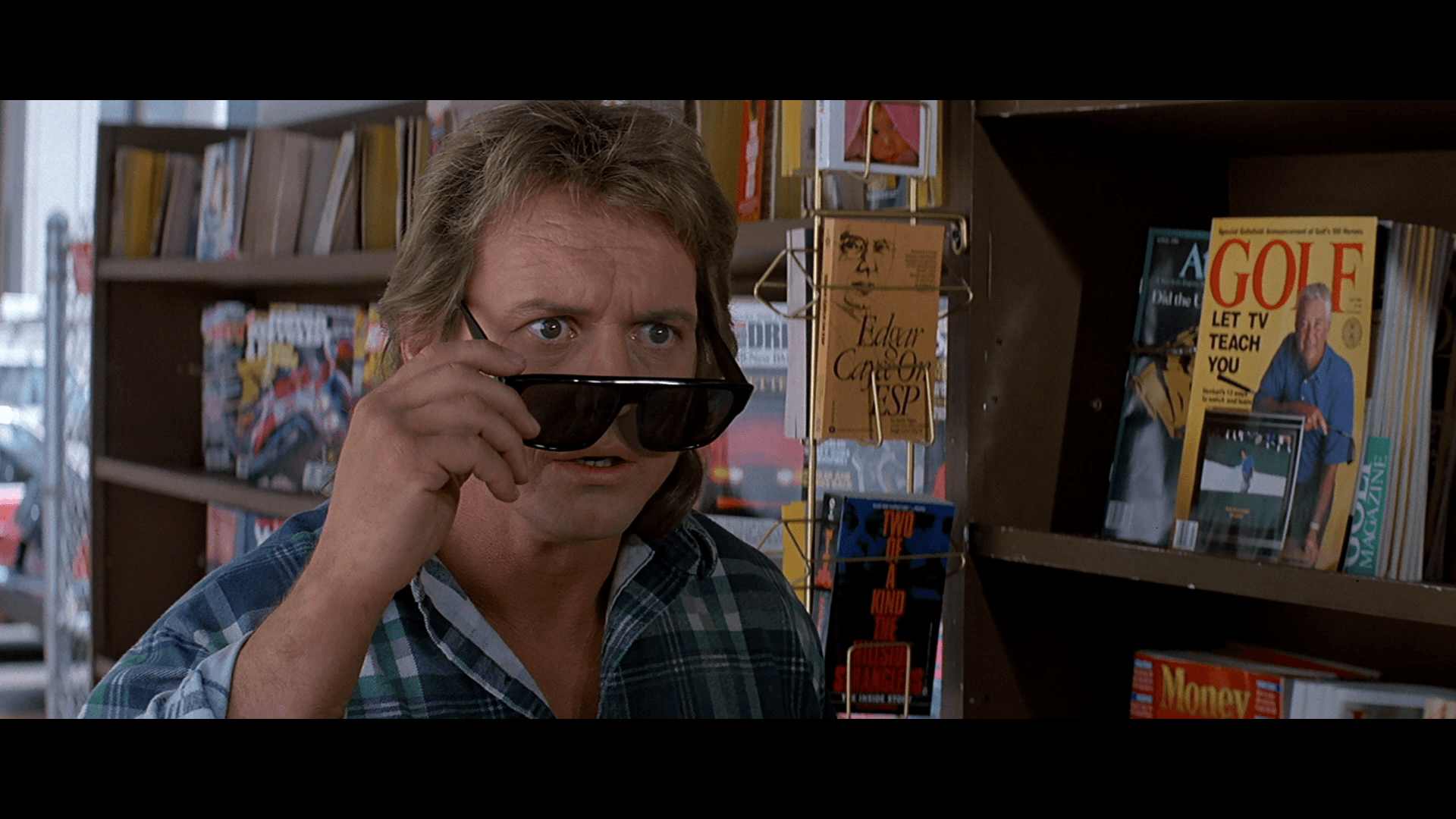 Scene from They Live where the protagonist puts on sunglasses revealing hidden messages, captioned All out of bubble gum